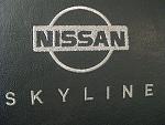 Nissan Skyline Logo Front Seats 06/07 Coupe (graphite)-logo-close-up.jpg